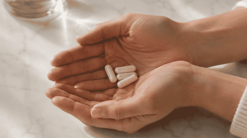 Person carefully holding magnesium supplement capsules representing the importance of knowing who should not take magnesium without medical guidance
