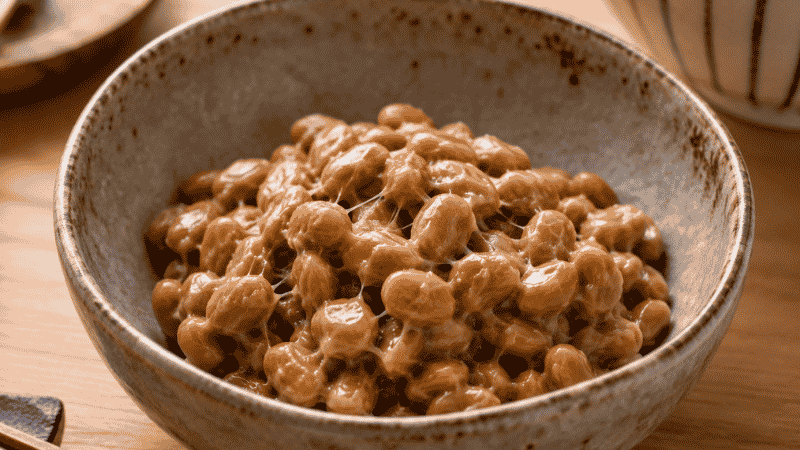 Bowl of natto fermented soybeans representing the richest dietary source of vitamin K2 MK-7 for bone and cardiovascular health