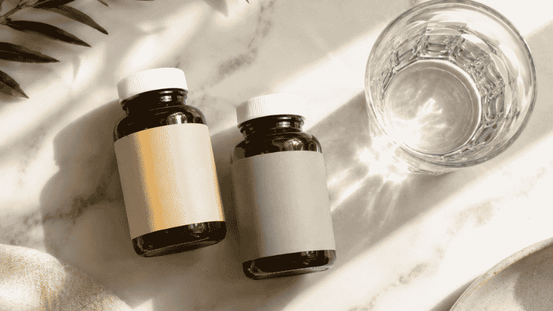 Two supplement bottles representing vitamin D and magnesium placed together showing their synergistic relationship for sleep and overall health