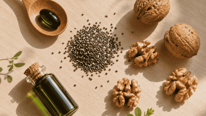 Algae oil supplement with plant-based omega-3 foods including chia seeds and walnuts representing algae oil as the vegan and vegetarian solution for DHA supplementation