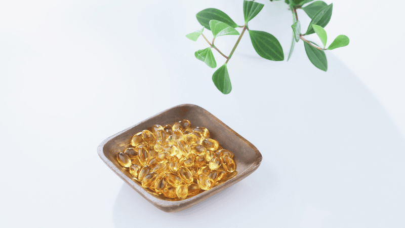 Close-up shot of high-quality Omega-3 fish oil softgels and herbal extract capsules representing standardized purity and scientifically-backed anti-inflammatory ingredients