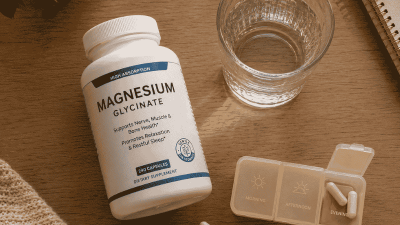 Magnesium glycinate supplement bottle with glass of water showing evening dosage routine